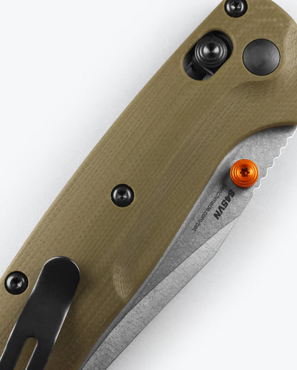 Benchmade 15534 Mini Taggedout OD green G10 handle closed with orange anodized thumb stud, barrel spacers and backspacer detail — ClassicBlades
