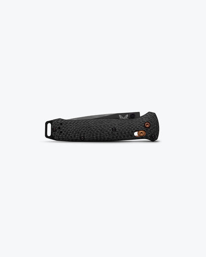 Benchmade 537BK-10 Bailout diamond-textured carbon fiber handle showing dark copper AXIS Lock and aluminum pommel detail — ClassicBlades