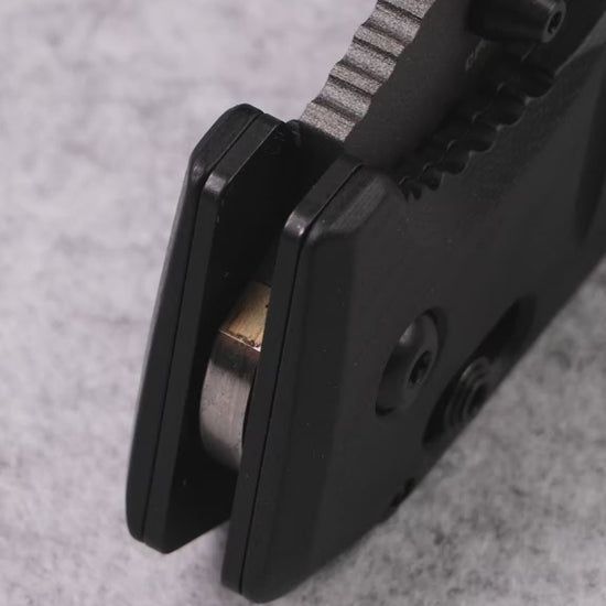 Black G10 handle folding knife designed for survival, camping, and outdoor adventures